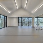 Loghaven's Performing Arts Studio with large windows, mirrors, and dance bar